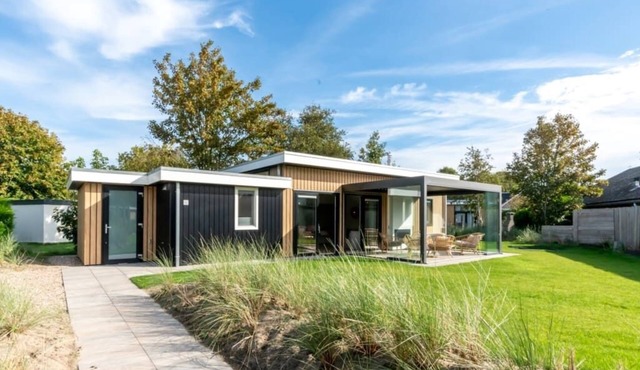 This chalet is the icing on the cake. Take a quick look inside! With a see-through fireplace, kitche in Burgh-Haamstede