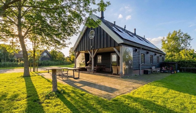 Waterfront home with an cozy outdoor fireplace in Kaag